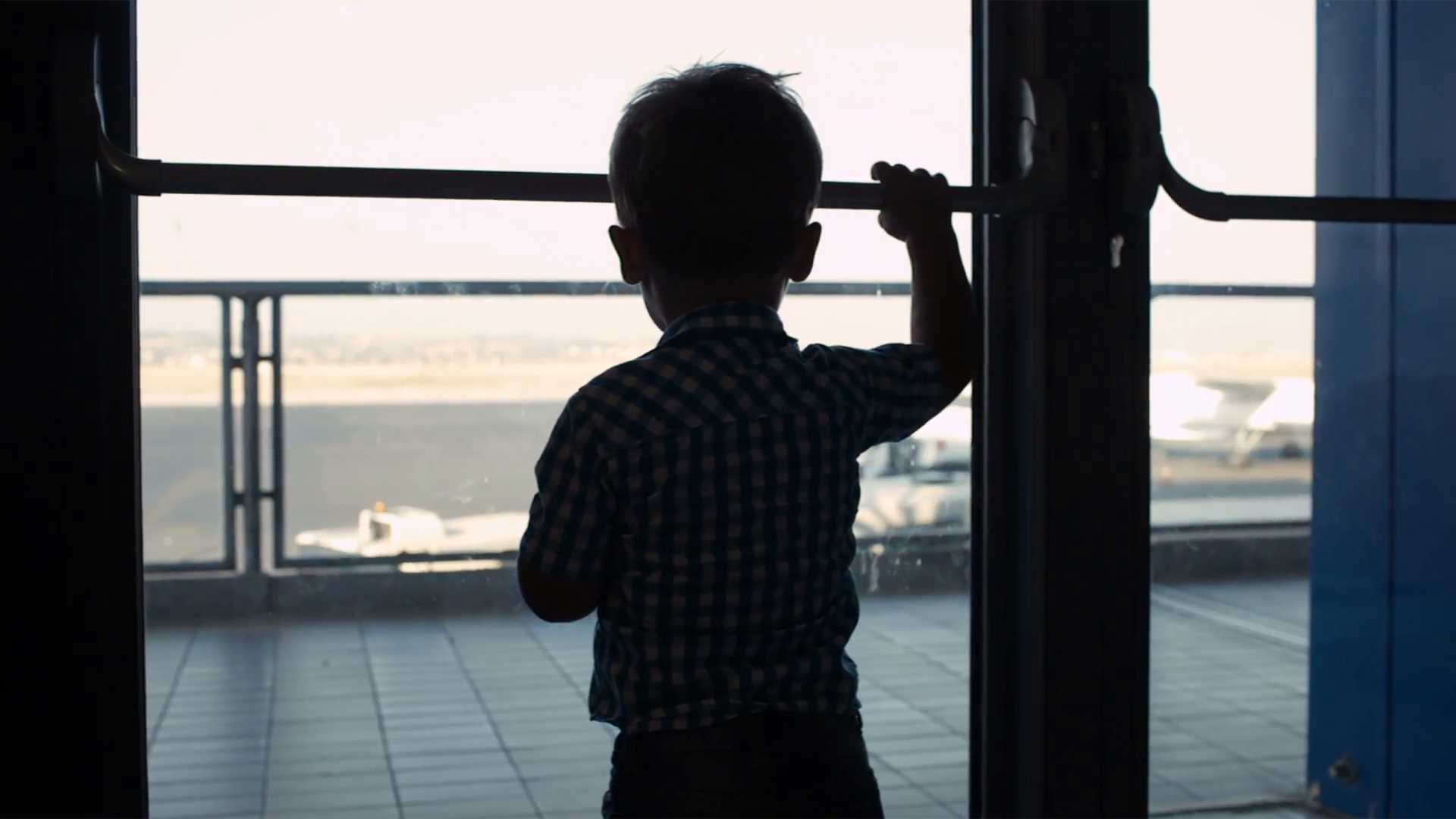 Silhouette of a young boy looking through a window in the airport to theairplanes in the landing strip Stock Video Footage - VideoBlocks, Boy Looking Out Window PNG - Free PNG