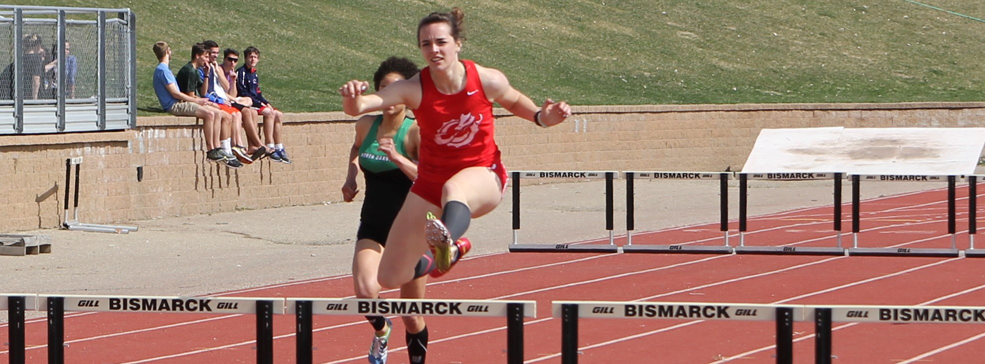 Hurdlers compete in the Distr